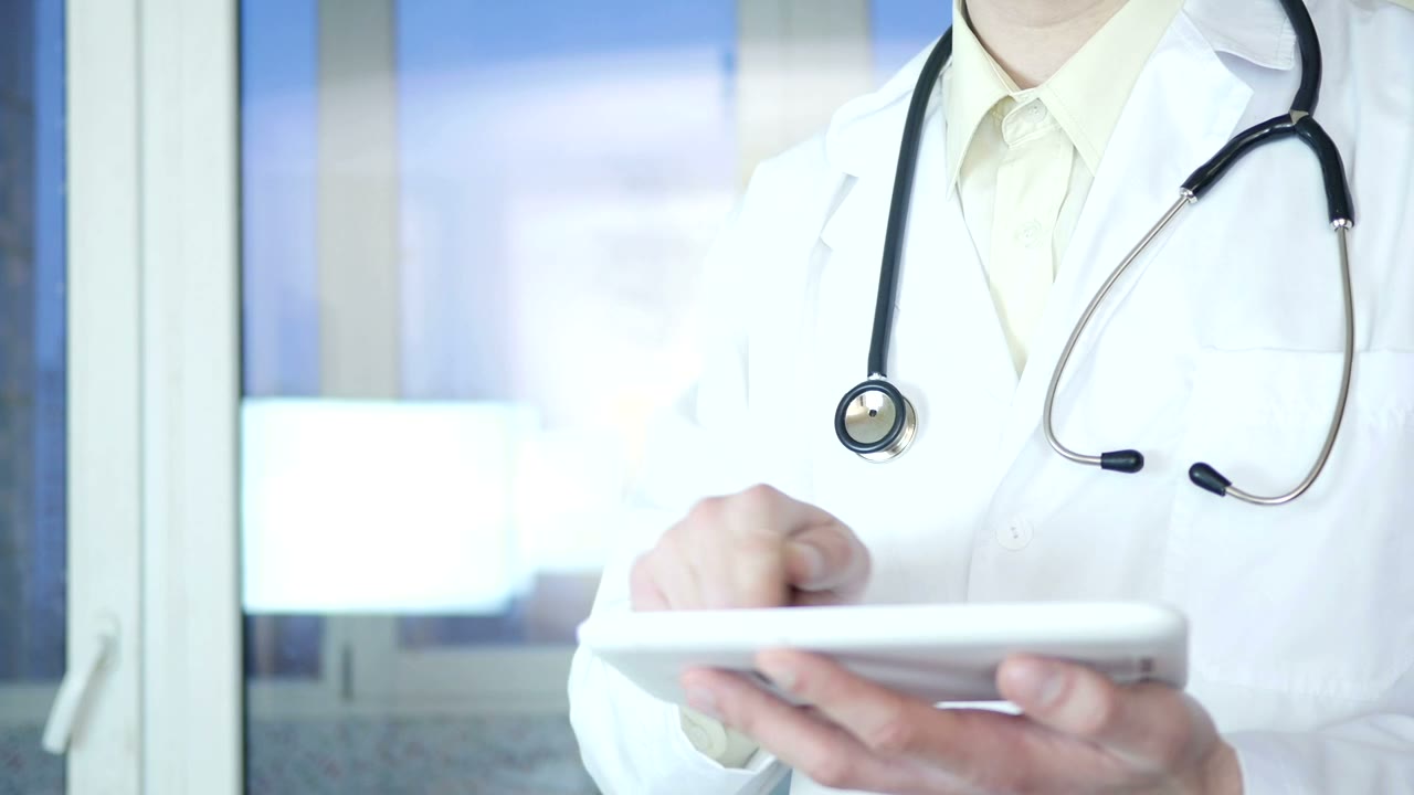 Physician reviewing information on a tablet